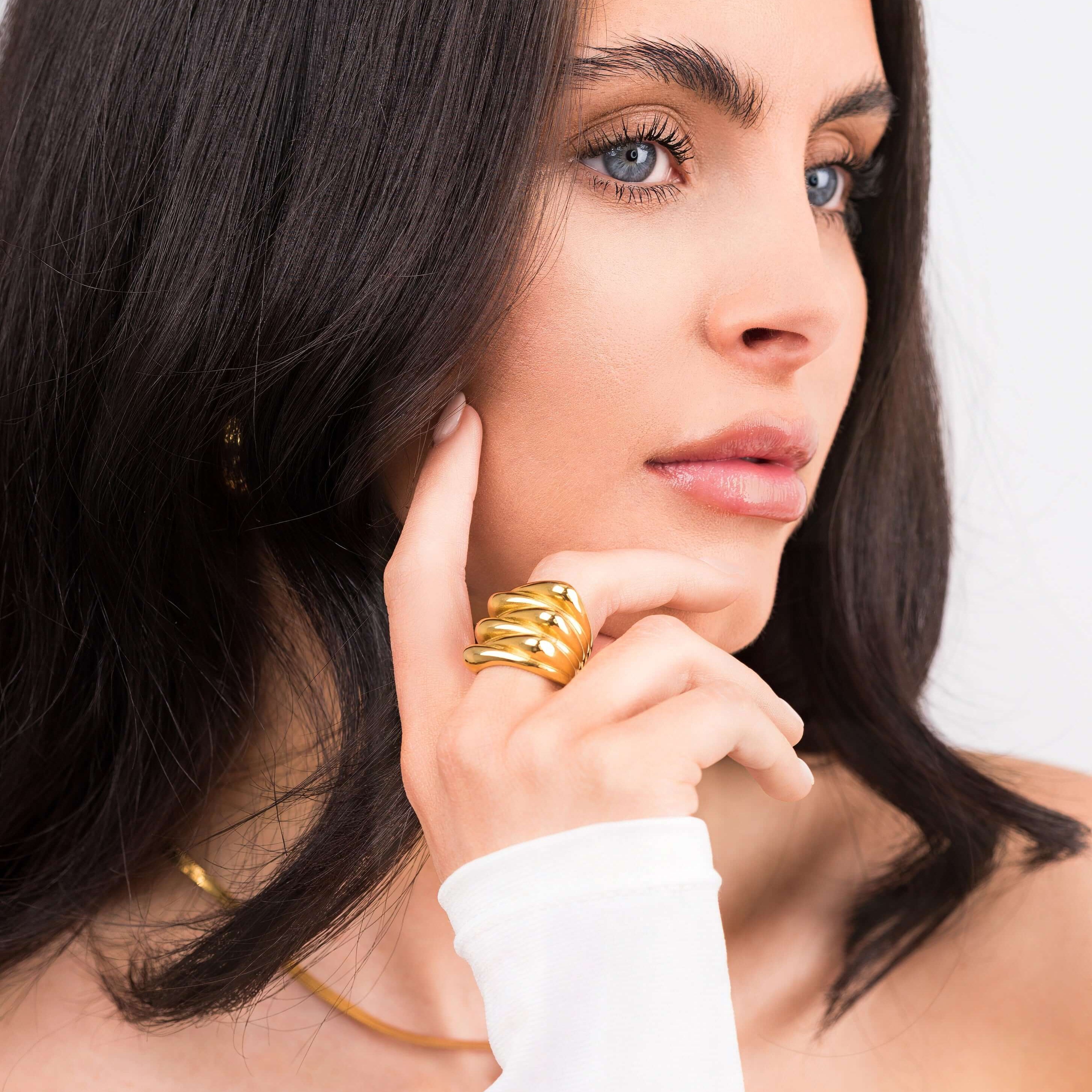 Model showcasing the Alina Gold Sculpted Statement Ring, featuring smooth ridges and a bold, elegant design.
