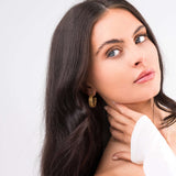 Model showcasing ARIIRA Elise Gold Teardrop Hoop Earrings, highlighting their sculptural design and high-shine finish.