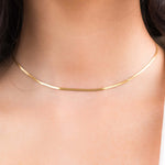 Ayla Herringbone Chain Necklace in Gold worn elegantly, showcasing its sleek design and high-quality gold-plated finish.