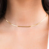 Ayla Herringbone Chain Necklace in Gold worn elegantly, showcasing its sleek design and high-quality gold-plated finish.