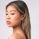 Model showcasing Lana Crescent Drop Earrings with a soft curve and high-shine finish against a neutral background.