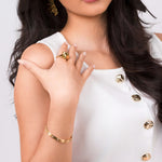 Model showcasing Nyla Fluid Form Sculpted Ring, with golden accessories, highlighting a modern and elegant style.