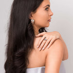Model displaying Agnes Water Drop Adjustable Ring, showcasing its elegant and fluid design alongside statement earrings.