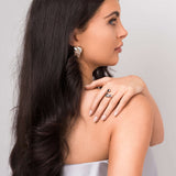 Model displaying Agnes Water Drop Adjustable Ring, showcasing its elegant and fluid design alongside statement earrings.
