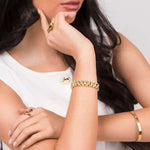 Model wearing the Raisa Sculpted Link Bracelet with crystal insets, showcasing stylish gold jewelry.