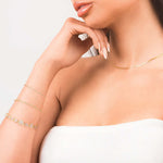 Model showcasing layered gold jewelry including the Lina Gold Twist Rope Chain Bracelet and a delicate gold necklace.