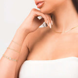 Model showcasing layered gold jewelry including the Lina Gold Twist Rope Chain Bracelet and a delicate gold necklace.