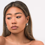 Model wearing Lyra Sculpted Mini Hoops, showcasing their modern, organic design and molten-inspired finish.