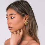 Mira sculpted stud earrings by ARIIRA, featuring gentle swirls and a lightweight, tarnish-free design, perfect for any style.