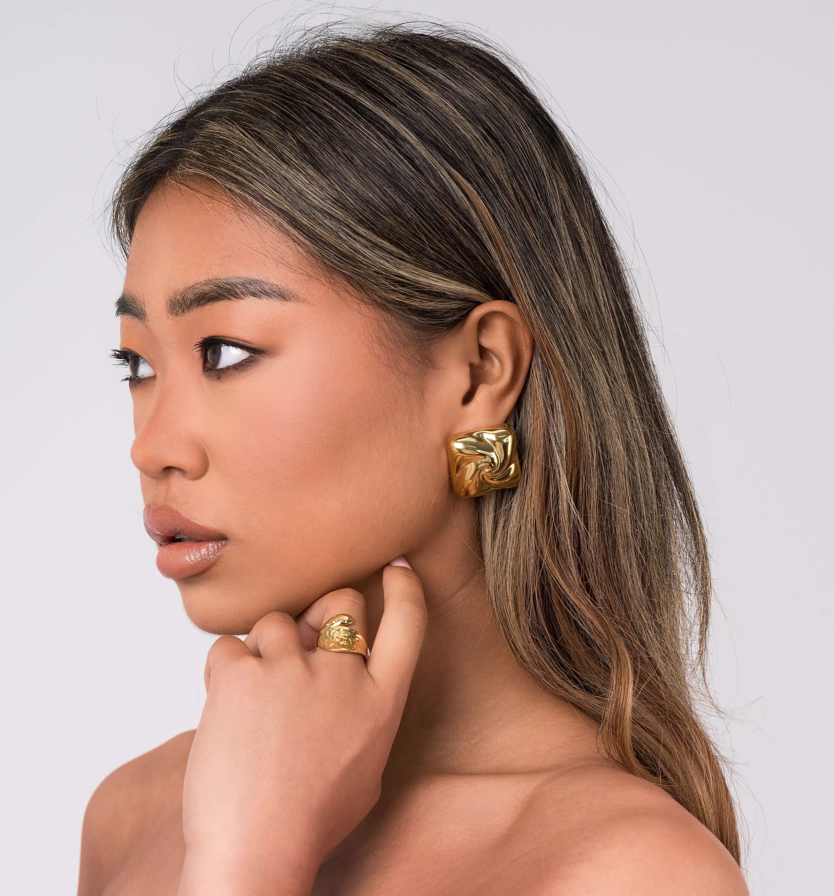 Mira sculpted stud earrings by ARIIRA, featuring gentle swirls and a lightweight, tarnish-free design, perfect for any style.
