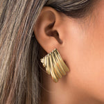 Gold Freya Sculpted Wave Hoops by ARIIRA, showcasing rhythmic ridged design in elegant silhouette.