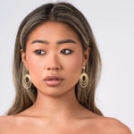 Elegant Elena Orbit Drop Earrings by ARIIRA featuring sculptural golden curves and a modern design.