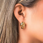 Ayla Textured Curve Hoop Earrings by ARIIRA, showcasing a polished and detailed dual finish in gold.