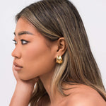 Model wearing ARIIRA Lyra Sculpted Mini Hoops showcasing their modern design and molten-inspired finish.