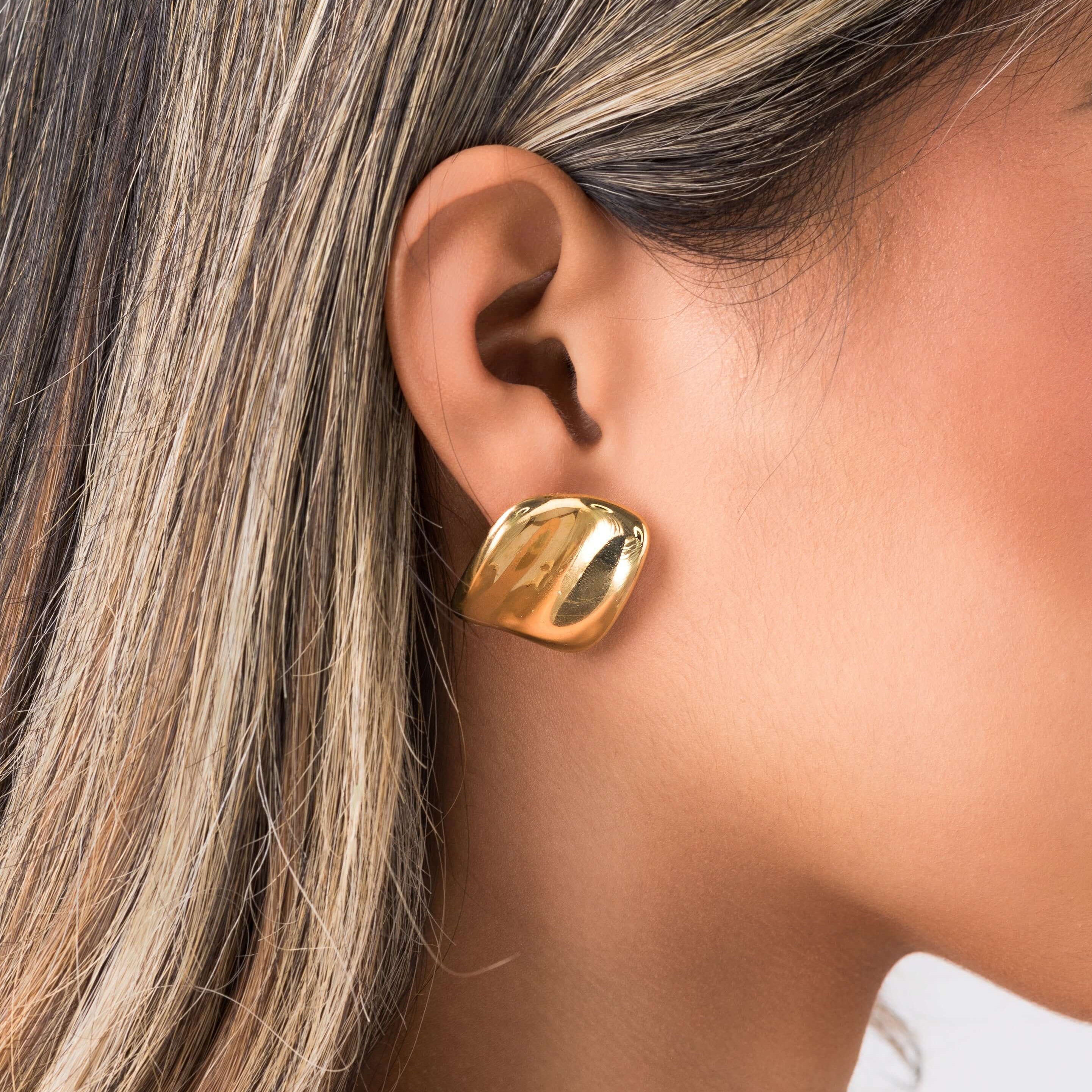 Lara Organic Drop Studs earrings by ARIIRA, showcasing a modern sculpted design with a polished golden surface.