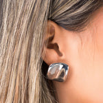 Close-up of a woman wearing ARIIRA Lara Organic Drop Studs, showcasing their modern design and polished surface.