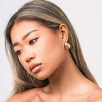 Saira Ribbed Dome Stud Earrings by ARIIRA, showcasing a lightweight and polished gold design for effortless style.
