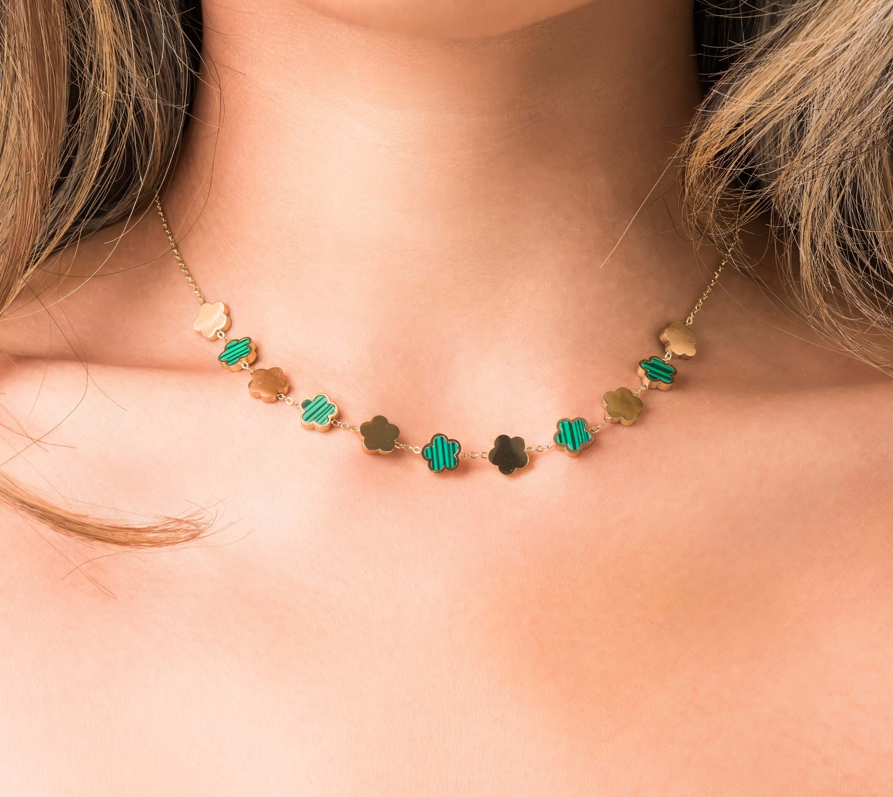 Elegant Soraya Enamel Clover Link Necklace by ARIIRA featuring gold-tone and green enamel clover links.