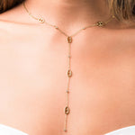 Mireya Y Drop chain necklace with oval motifs by ARIIRA, featuring delicate gold links and sparkling stones.