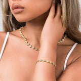 Close-up of a woman wearing the ARIIRA Safa Crystal Flower Link Bracelet and matching necklace, showcasing elegance and sparkle.