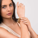 Model showcasing the ARIIRA Zehra Textured Spiral Wrap Ring with modern gold jewellery.