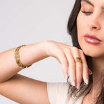 Model showcasing the Lena Layered Black Stone Ring by ARIIRA, featuring a bold design with a black stone and gold band.