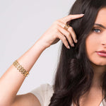 Lena Layered Black Stone Ring by ARIIRA worn by a model, showcasing gold band and elegant design.