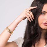 Lena Layered Black Stone Ring by ARIIRA worn by a model, showcasing gold band and elegant design.