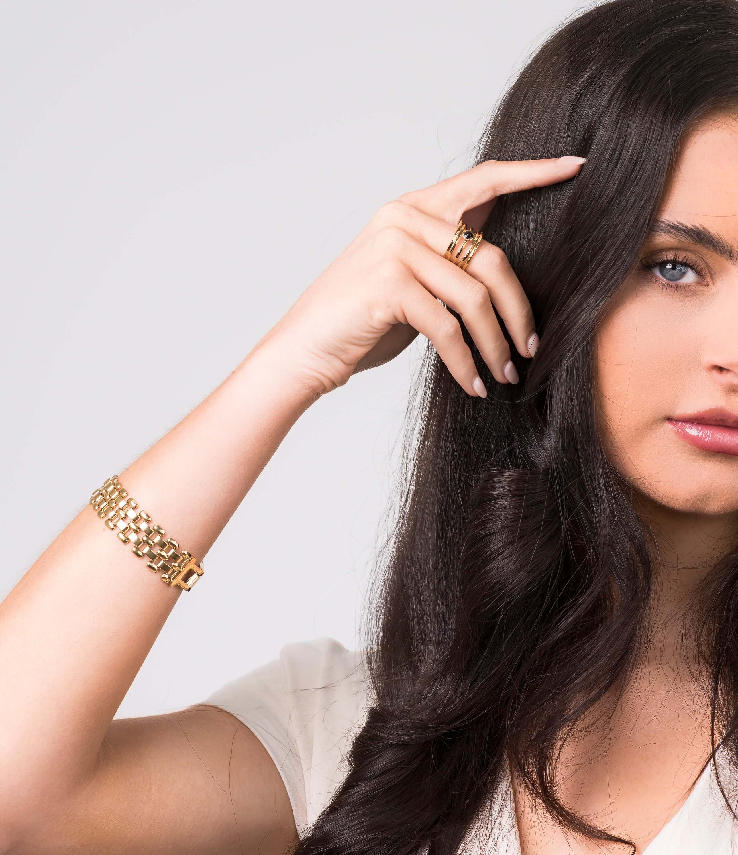 Lena Layered Black Stone Ring by ARIIRA worn by a model, showcasing gold band and elegant design.