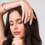 Model wearing ARIIRA Alina Textured Shell Gold Ring, showcasing its elegant design and adjustable fit.