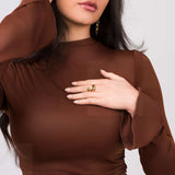 Woman wearing the Agnes Water Drop Adjustable Ring by ARIIRA, showcasing its elegant design on her hand.