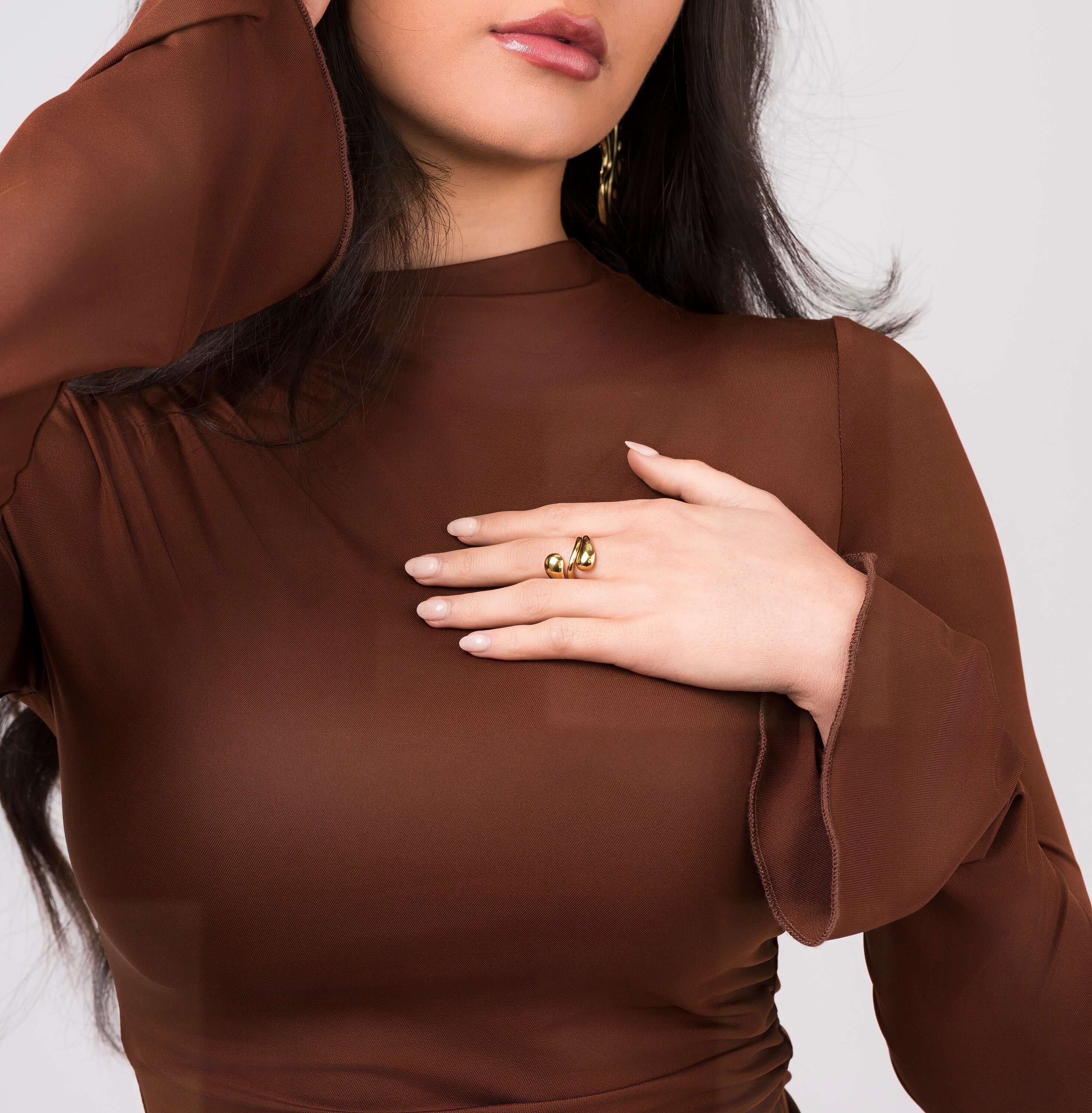 Woman wearing the Agnes Water Drop Adjustable Ring by ARIIRA, showcasing its elegant design on her hand.