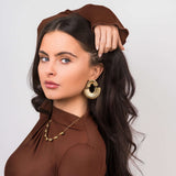 Model showcasing Layali Sculpted Fan Drop Earrings by ARIIRA, featuring a bold, lightweight design and a stunning silhouette.