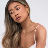 Hallie Rope Chain Necklace with Spiral Medallion worn by a model, showcasing elegance and modern design.
