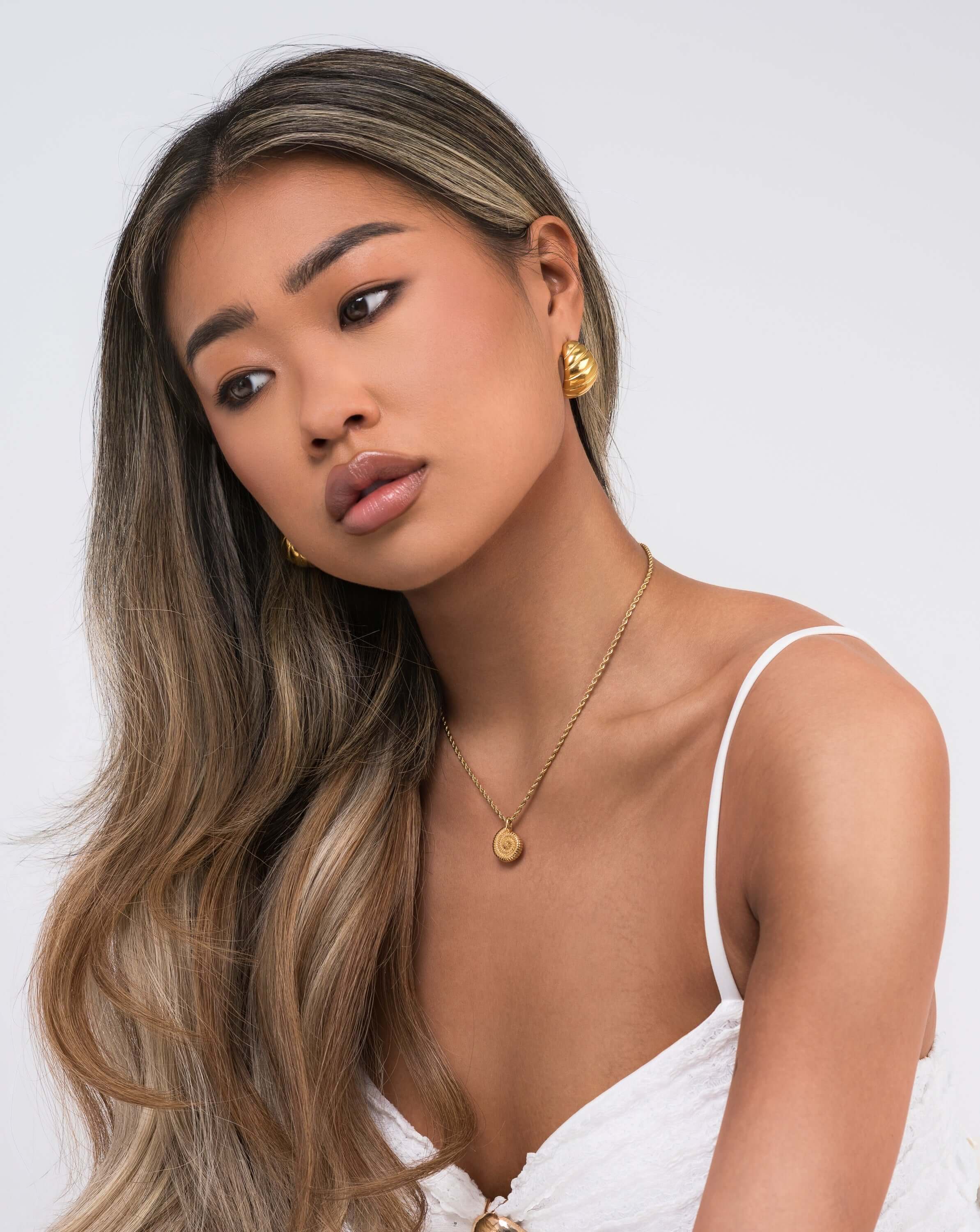 Hallie Rope Chain Necklace with Spiral Medallion worn by a model, showcasing elegance and modern design.