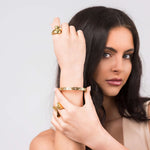 Close-up of a woman wearing the Ameera Lattice Engraved Gold Bangle Bracelet, showcasing its crisscross engraving and elegant design.