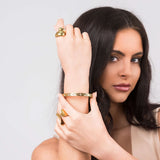 Close-up of a woman wearing the Ameera Lattice Engraved Gold Bangle Bracelet, showcasing its crisscross engraving and elegant design.