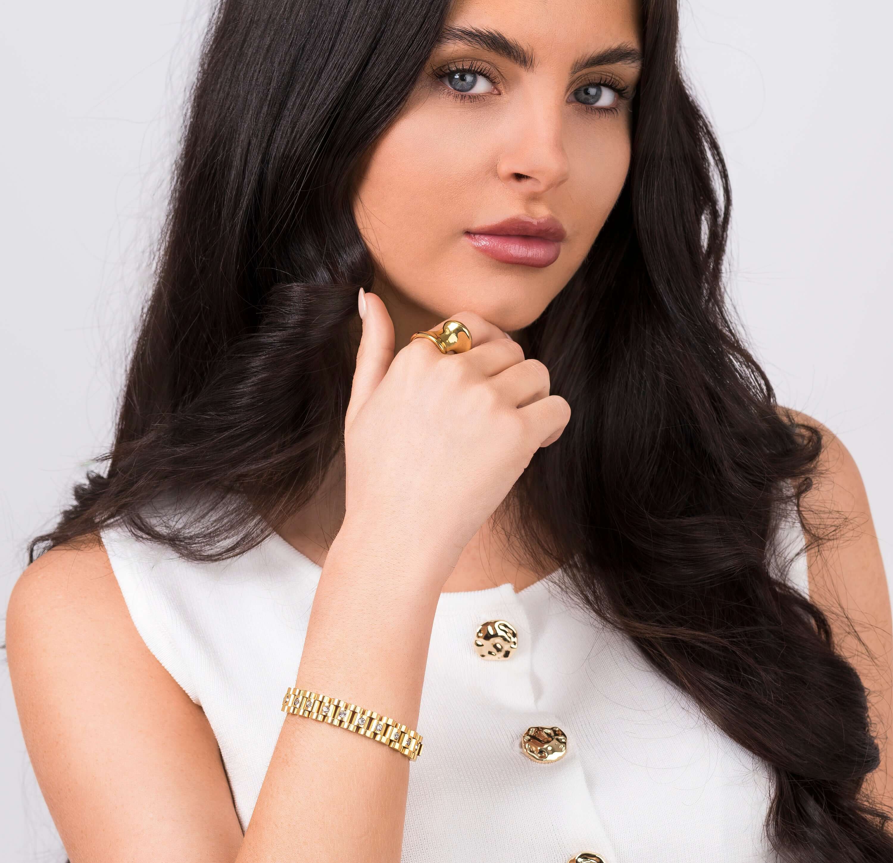 Model showcasing the ARIIRA Raisa Sculpted Link Bracelet with crystal insets and a fashionable ring.