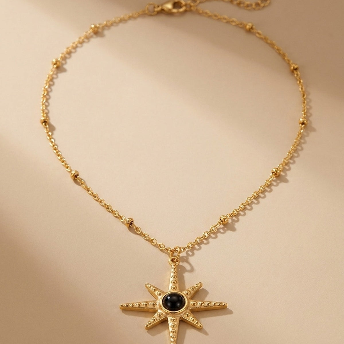 gold Gaia Gold Tone Starburst Pendant Necklace