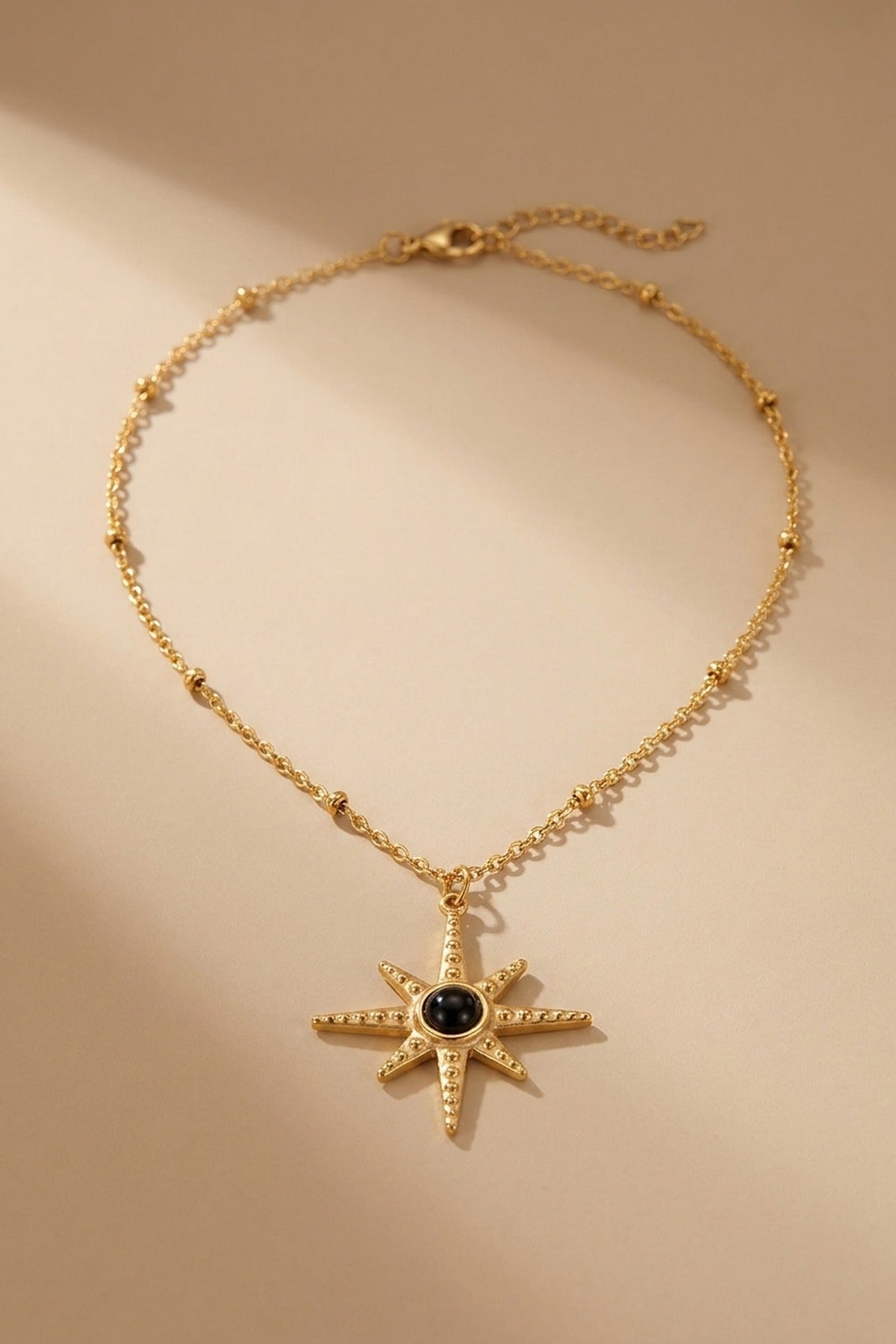 gold Gaia Gold Tone Starburst Pendant Necklace