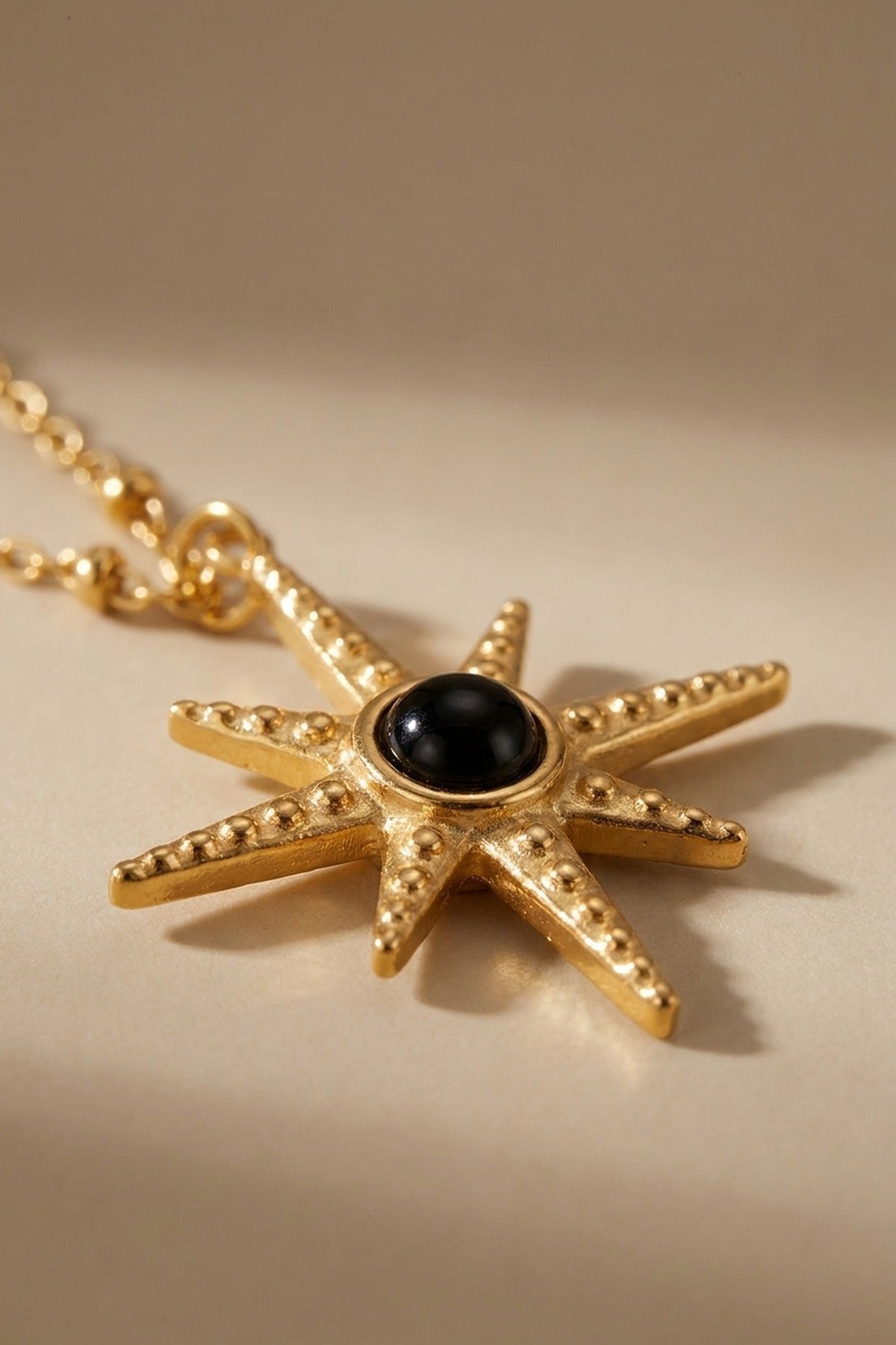 gold Gaia Gold Tone Starburst Pendant Necklace