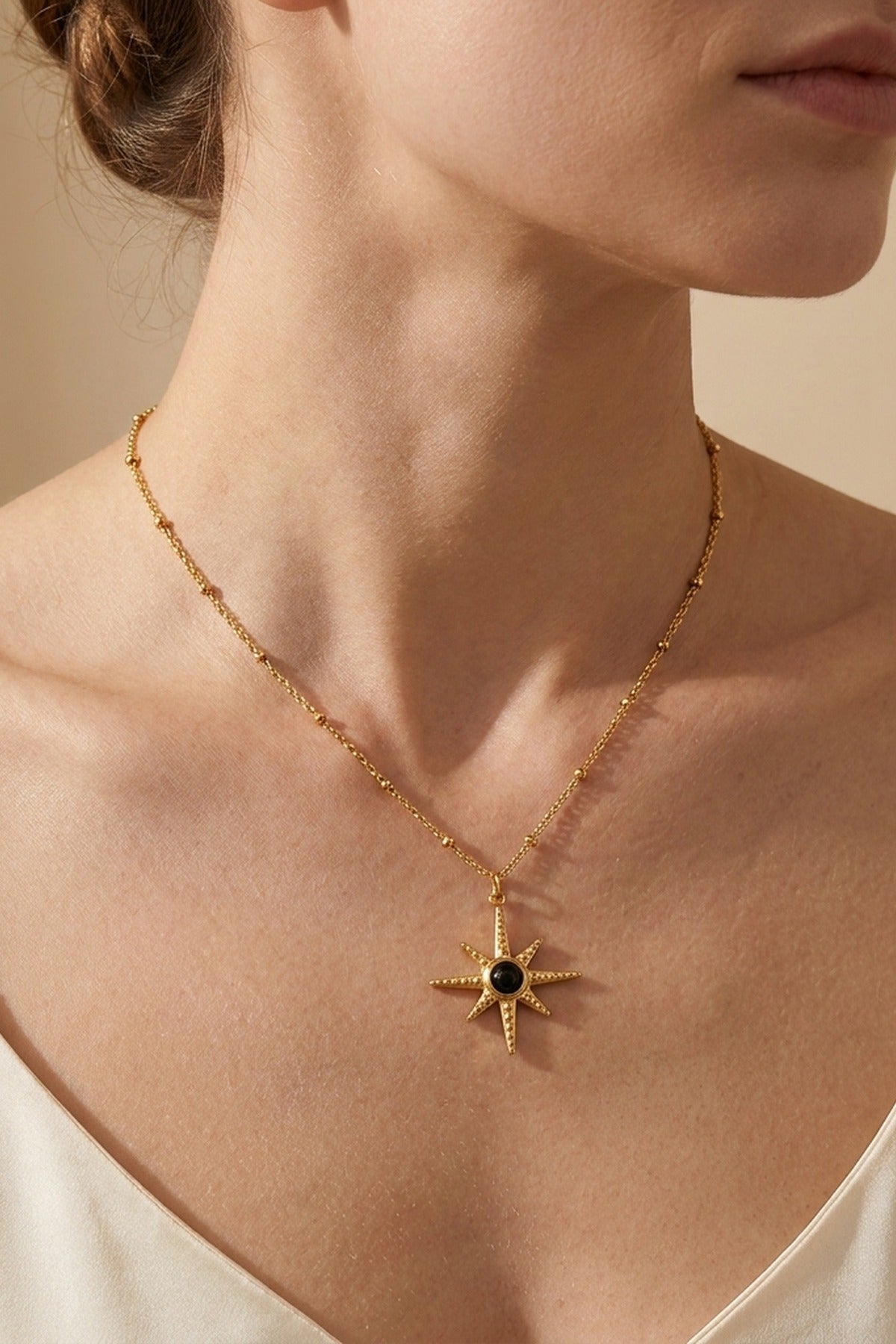 gold Gaia Gold Tone Starburst Pendant Necklace