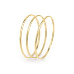 Mira set of three gold bangles by ARIIRA with sleek polished finish for elegant, versatile styling.