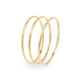 Mira set of three gold bangles by ARIIRA with sleek polished finish for elegant, versatile styling.