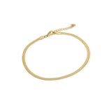 Layla Gold Herringbone Anklet by ARIIRA, a delicate gold-plated stainless steel anklet with a luxurious herringbone design.