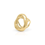 Sculptural gold statement ring by ARIIRA with organic curves and open center, reflecting light beautifully.