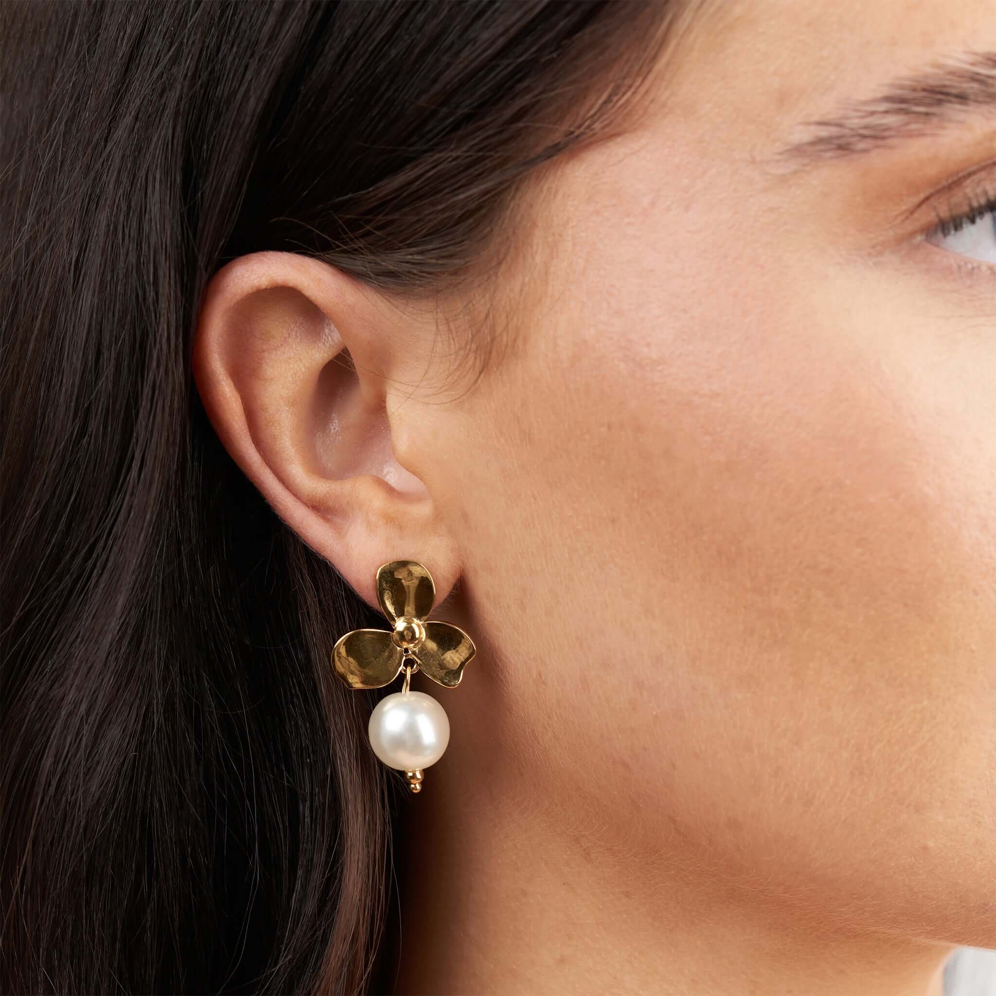 Leila Pearl Flower Drop Earrings by ARIIRA featuring floral design and pearl drop.