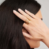 Liana Triple Curve Ring by ARIIRA, showcasing an elegant triple-curve silhouette on a woman's hand.