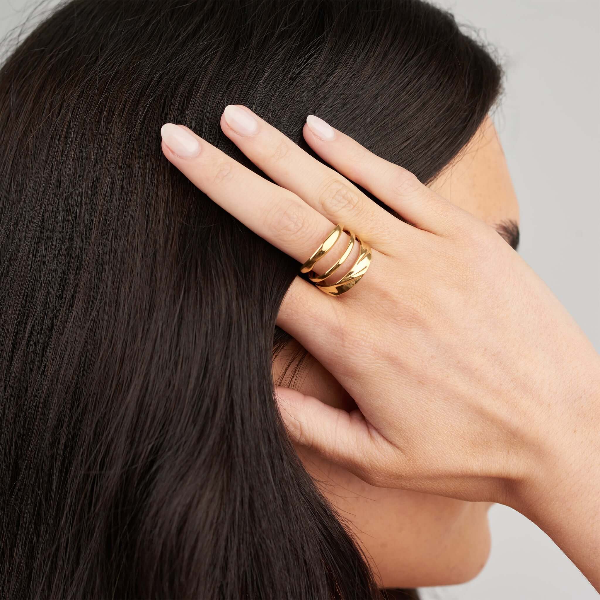 Liana Triple Curve Ring by ARIIRA, showcasing an elegant triple-curve silhouette on a woman's hand.