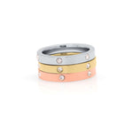 Kaia Triple Tone Crystal Ring Set by ARIIRA featuring stacked rose, gold, and silver bands with crystals.